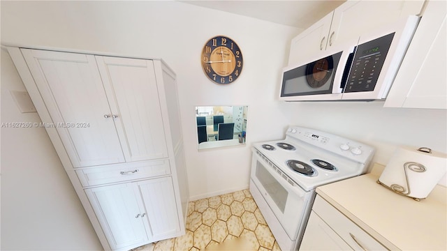 kitchen with white cabinetry and white appliances