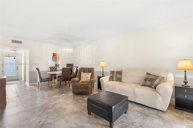 living room with a notable chandelier, ornamental molding, and tile patterned floors