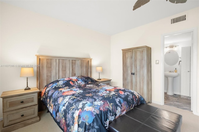 carpeted bedroom featuring sink, ceiling fan, and connected bathroom