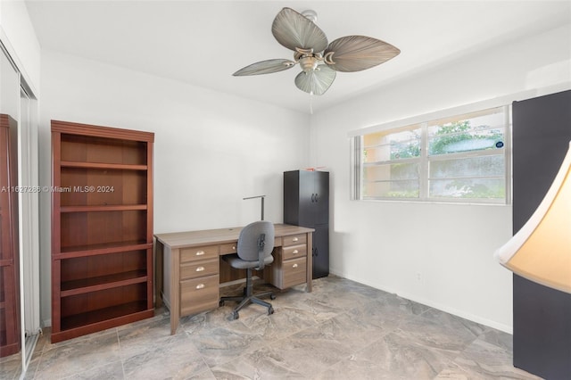 tiled office space featuring ceiling fan