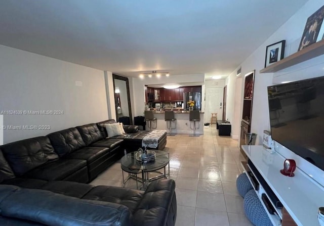 living room featuring light tile patterned flooring and track lighting