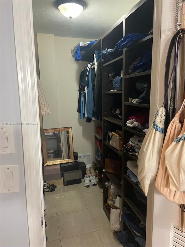 walk in closet featuring tile patterned flooring