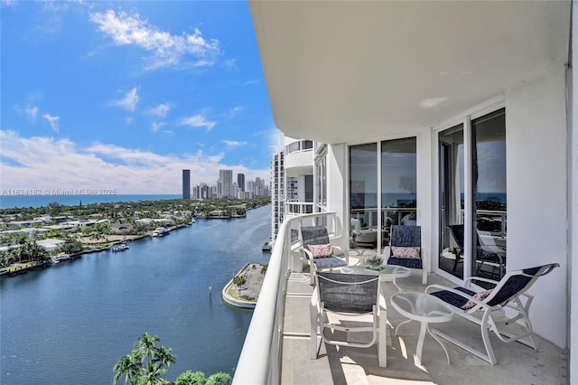 balcony with a view of city and a water view