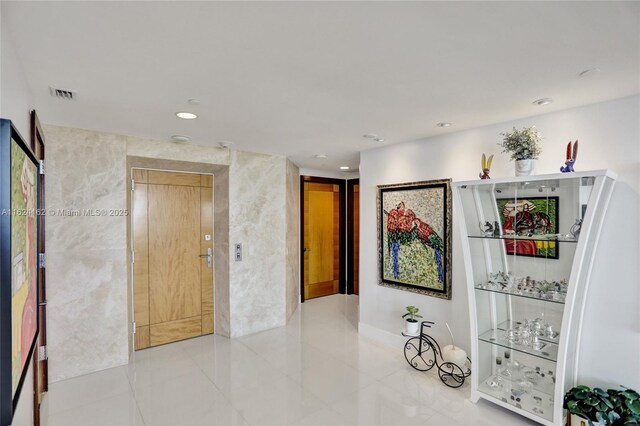 living room featuring light tile patterned floors and a wall of windows