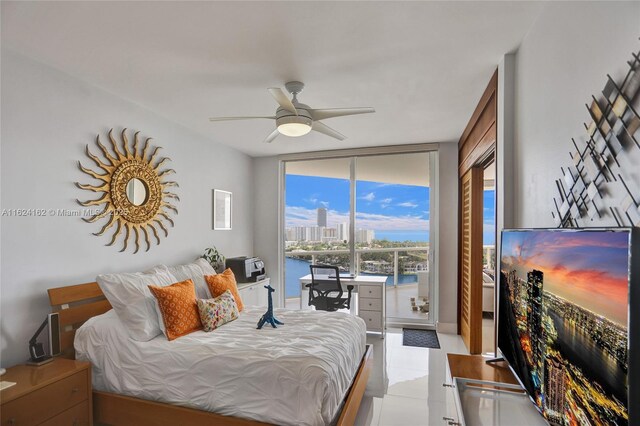 bedroom featuring ceiling fan, access to exterior, and expansive windows