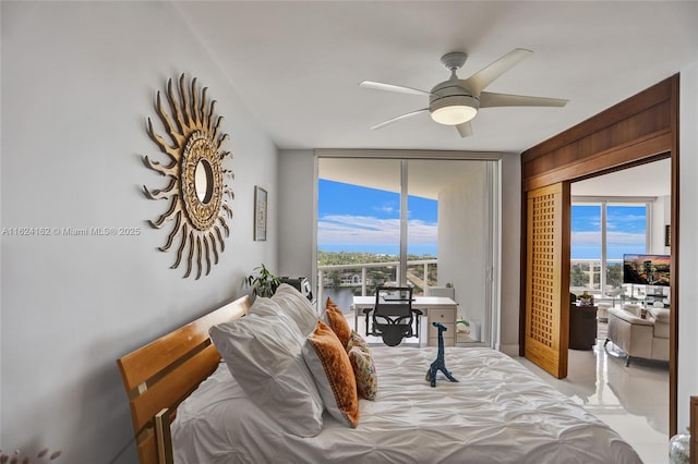 bedroom with ceiling fan, a wall of windows, access to outside, and light tile patterned floors