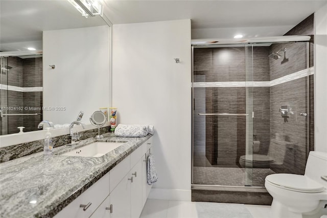 bathroom with a shower with shower door, tile patterned floors, toilet, and vanity