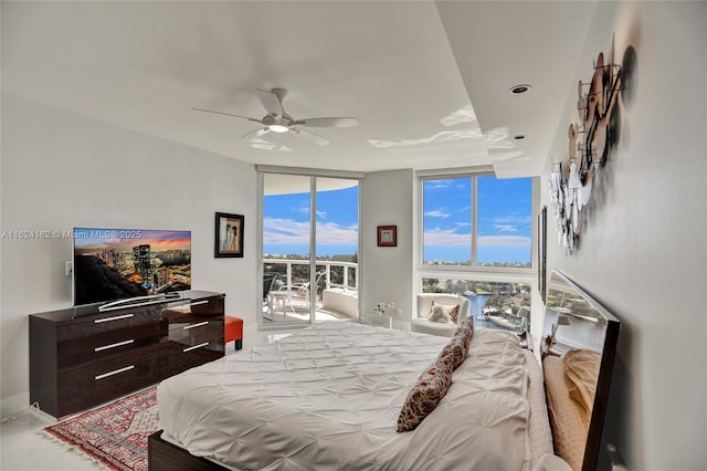 bedroom with access to outside, expansive windows, and ceiling fan