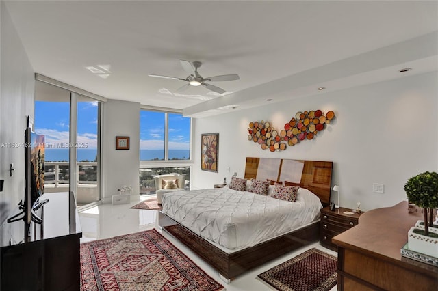 bedroom with ceiling fan, a wall of windows, access to exterior, and multiple windows