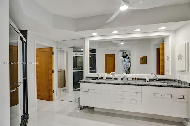 bathroom featuring ceiling fan, recessed lighting, a sink, and double vanity