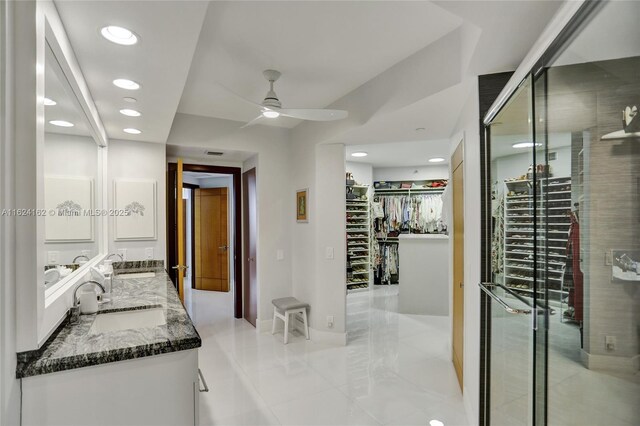 bedroom with ceiling fan, access to exterior, and expansive windows