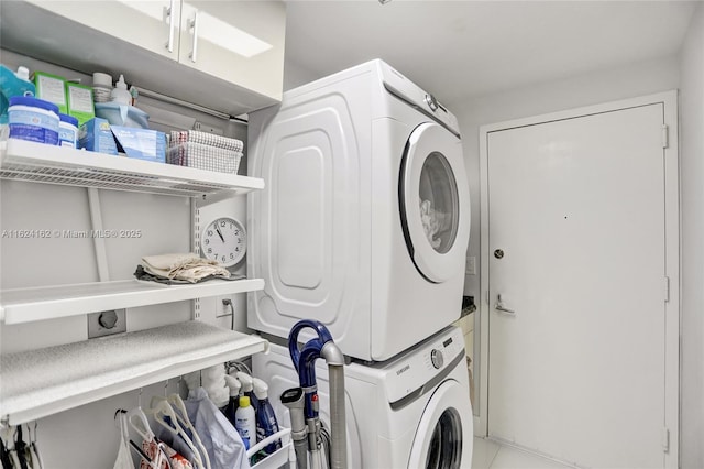 laundry area with stacked washer / drying machine