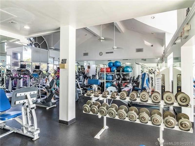 exercise room with high vaulted ceiling and visible vents