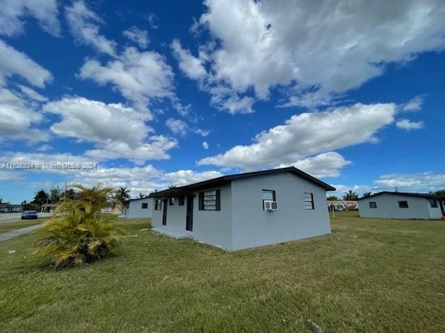 view of side of property with a yard