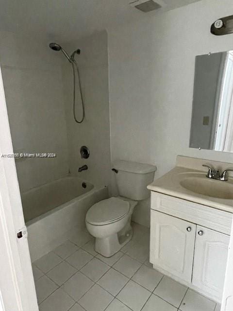 full bathroom with tile patterned floors, toilet, tiled shower / bath, and vanity