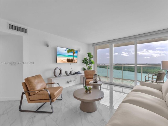 tiled living room featuring expansive windows and plenty of natural light