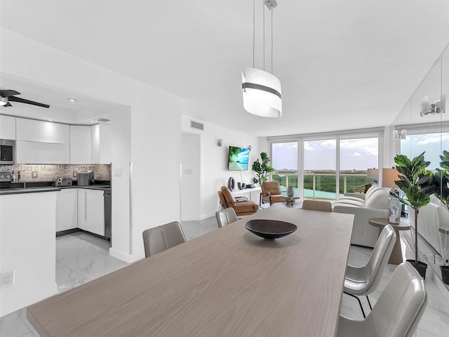 tiled dining space featuring ceiling fan