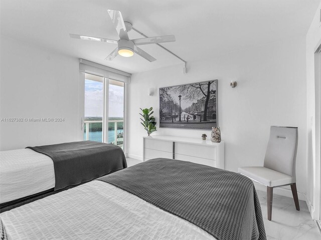 bedroom with light tile patterned floors, a water view, and ceiling fan