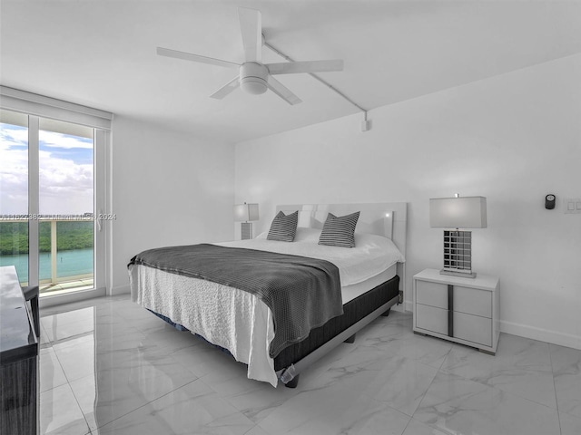 bedroom featuring a water view, multiple windows, light tile patterned floors, and ceiling fan