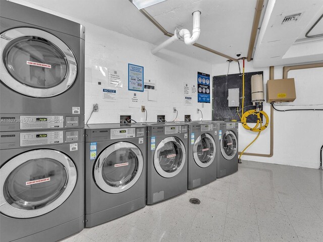 clothes washing area featuring light tile patterned floors, stacked washer / drying machine, and independent washer and dryer