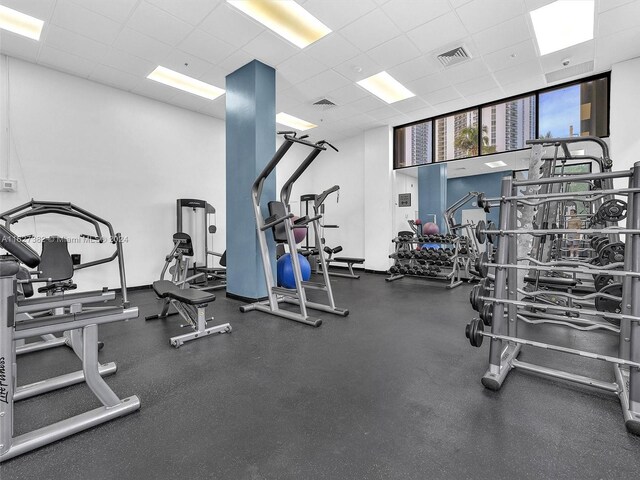 exercise room with a paneled ceiling