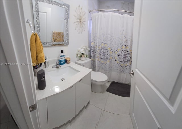 bathroom with vanity, tile patterned flooring, and toilet