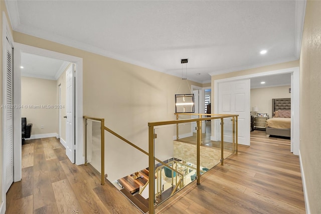 7949 NW 188th Ter, Hialeah, FL 33015 - hallway with an upstairs landing, crown molding, wood finished floors, and recessed lighting