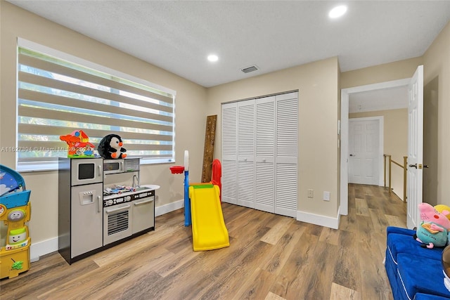 7949 NW 188th Ter, Hialeah, FL 33015 - game room with light wood-style flooring and recessed lighting