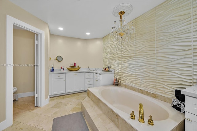 bathroom with vanity, tile patterned flooring, tiled bath, and toilet