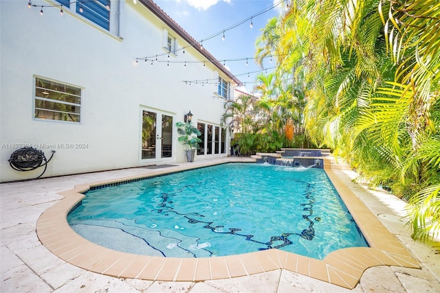7949 NW 188th Ter, Hialeah, FL 33015 - outdoor pool featuring french doors, a hot tub, and a patio