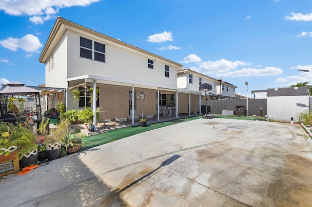 rear view of property featuring a patio