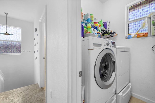 clothes washing area featuring washer and clothes dryer