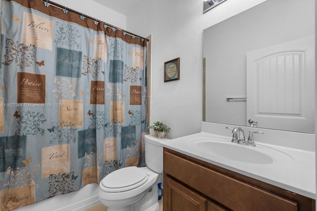 full bathroom with vanity, shower / tub combo, and toilet