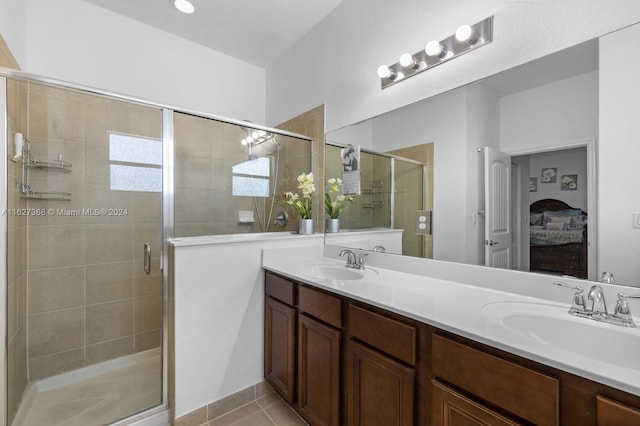 bathroom featuring walk in shower, tile patterned flooring, and dual bowl vanity