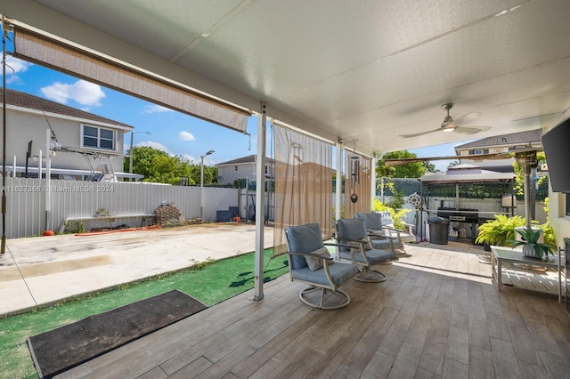 deck with ceiling fan, a patio area, and a gazebo