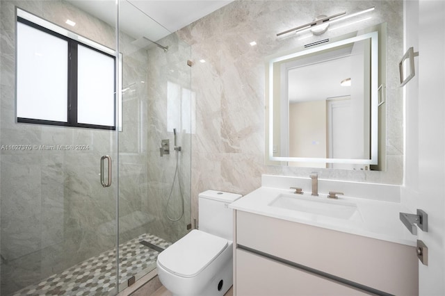 bathroom with toilet, an enclosed shower, tile walls, and vanity