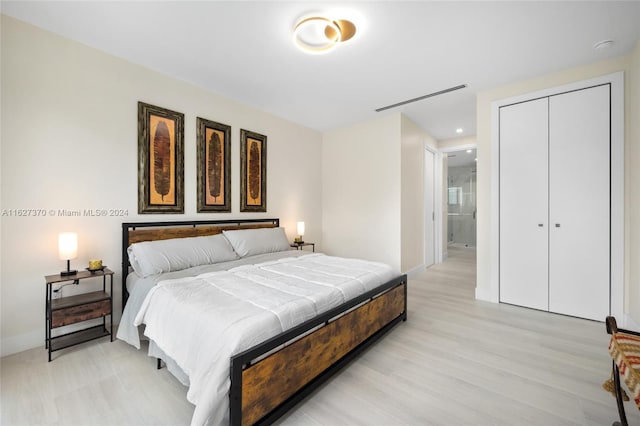 bedroom featuring light hardwood / wood-style floors and a closet