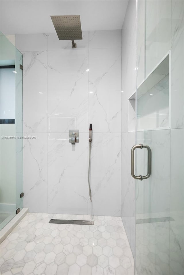 bathroom with a shower with door