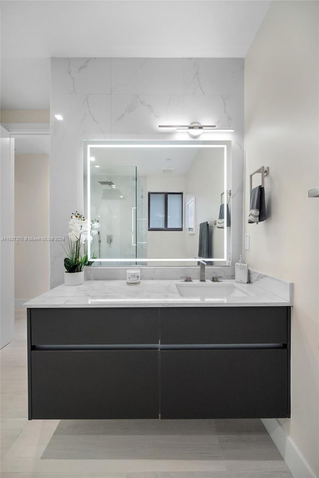 bathroom with a shower and vanity