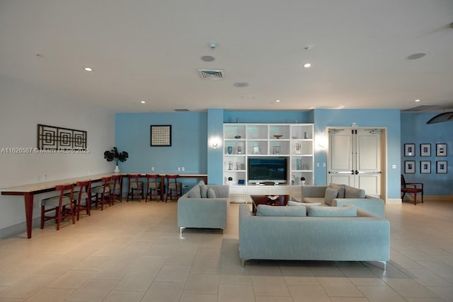 living area with recessed lighting, visible vents, baseboards, and light tile patterned floors