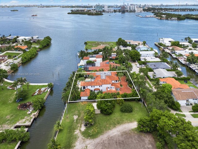 birds eye view of property with a water view