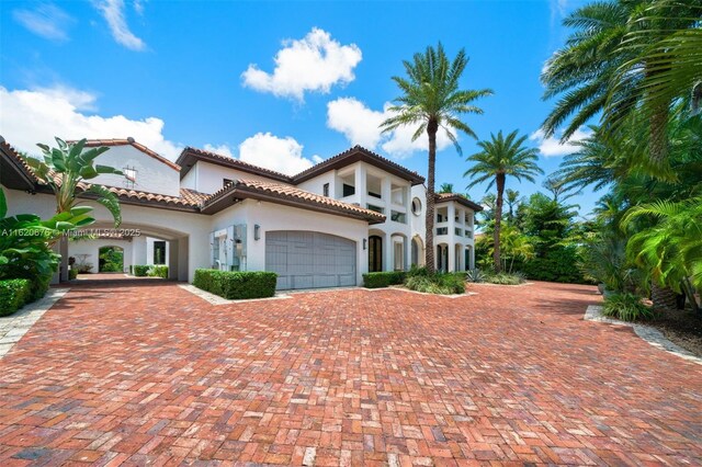 mediterranean / spanish home featuring a garage