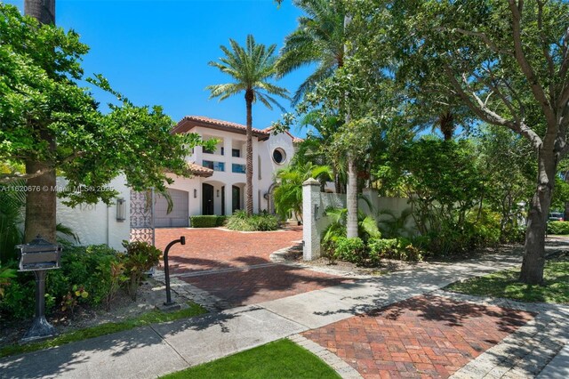 mediterranean / spanish home featuring a garage