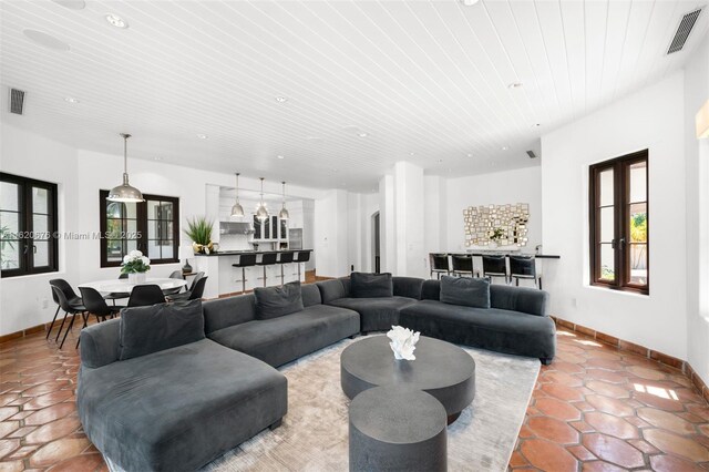 tiled living room with french doors and wooden ceiling