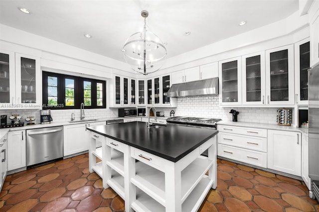 kitchen with white cabinets, decorative light fixtures, stainless steel appliances, and sink