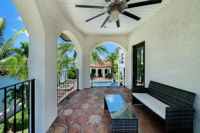 view of patio with a balcony and ceiling fan