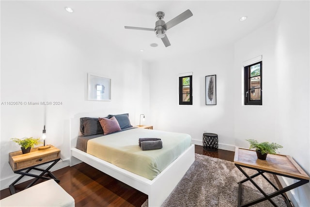 bedroom with ceiling fan and dark wood-type flooring