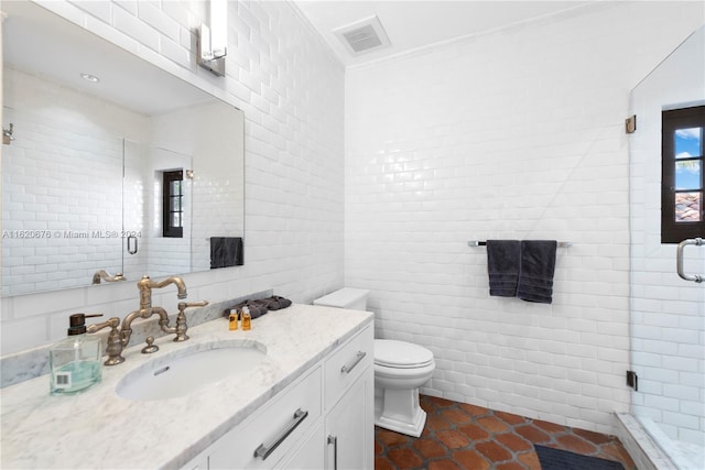 bathroom with crown molding, an enclosed shower, toilet, vanity, and tile walls