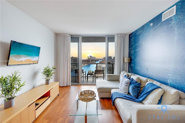 2602 E Hallandale Beach Blvd Unit R2009, Hallandale Beach, FL 33009 - living room with expansive windows, visible vents, and light wood finished floors