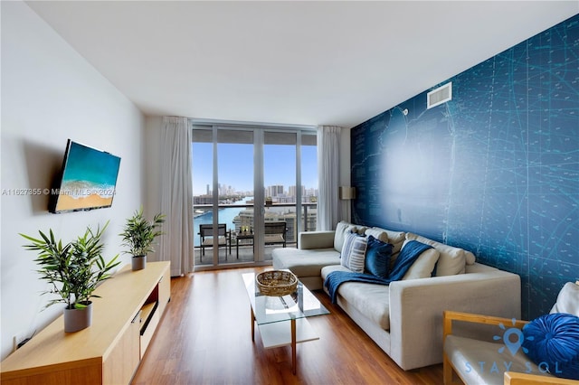 2602 E Hallandale Beach Blvd Unit R2009, Hallandale Beach, FL 33009 - living area featuring wood finished floors, visible vents, and expansive windows